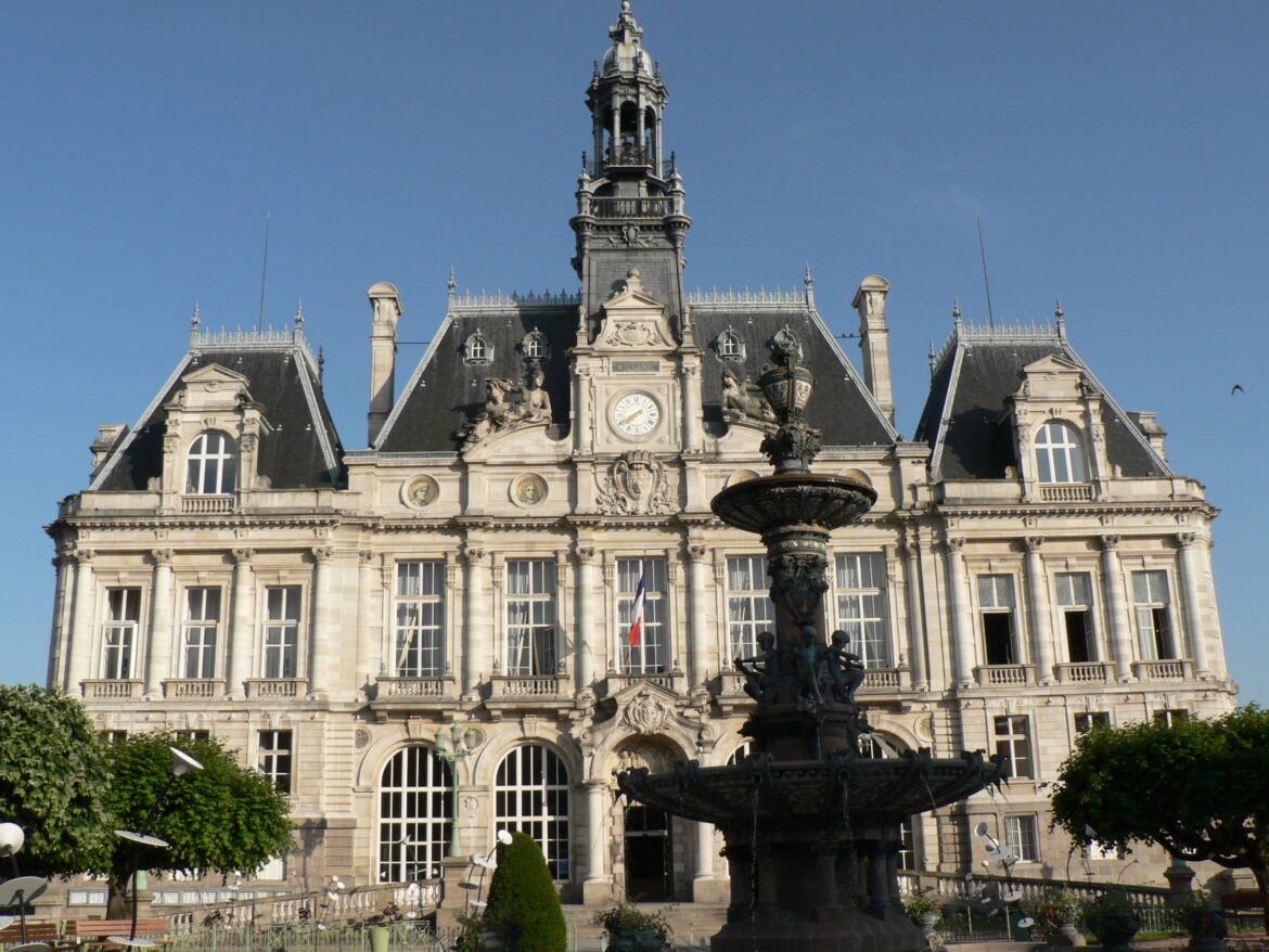 Limoges town hall, a 19th-century building with a central bell tower and a fountain in front, before the October 2026 fire.