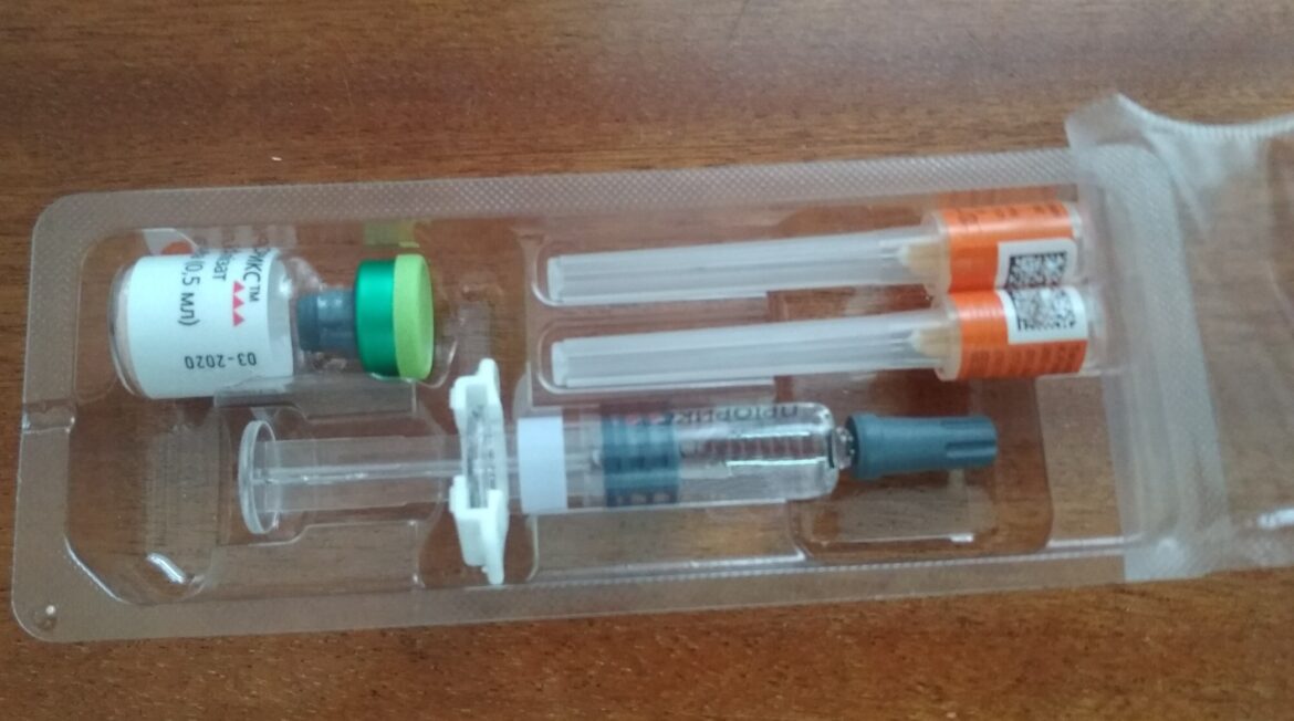 Priorix MMR vaccine pack with a vial and syringes on a table