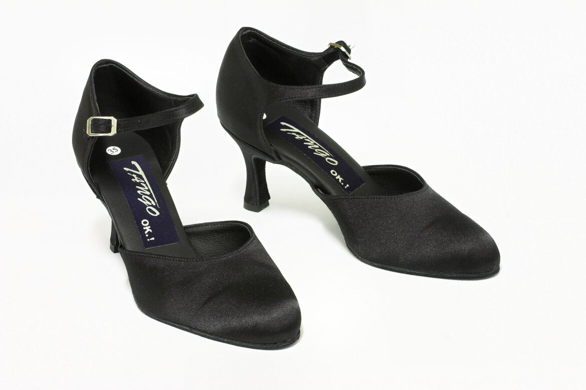 Pair of black women's ballroom dance shoes with ankle straps on a white background